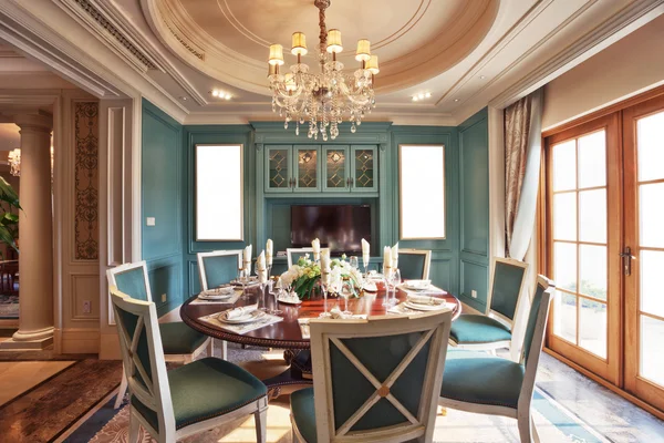 Dining room with teal blue and warm neutral paint and natural wood finishes by an interior painter in Monmouth, OR.