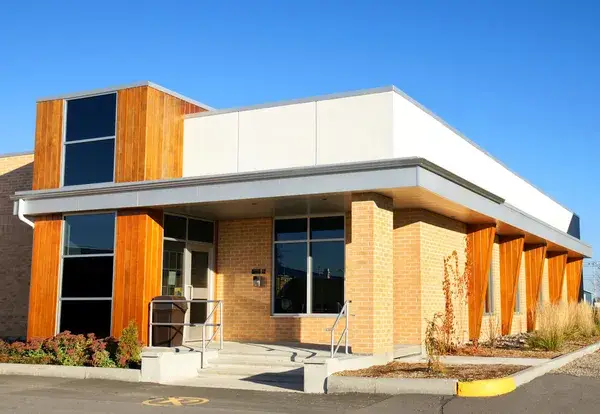 Commercial building with warm wood paneling, cream-colored walls and textured finishes by a painting company in Lebanon, OR.