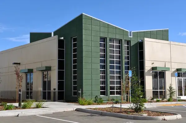 Building with dark green, beige exterior paint, and smooth matte finishes by a painting company in Lebanon, OR.